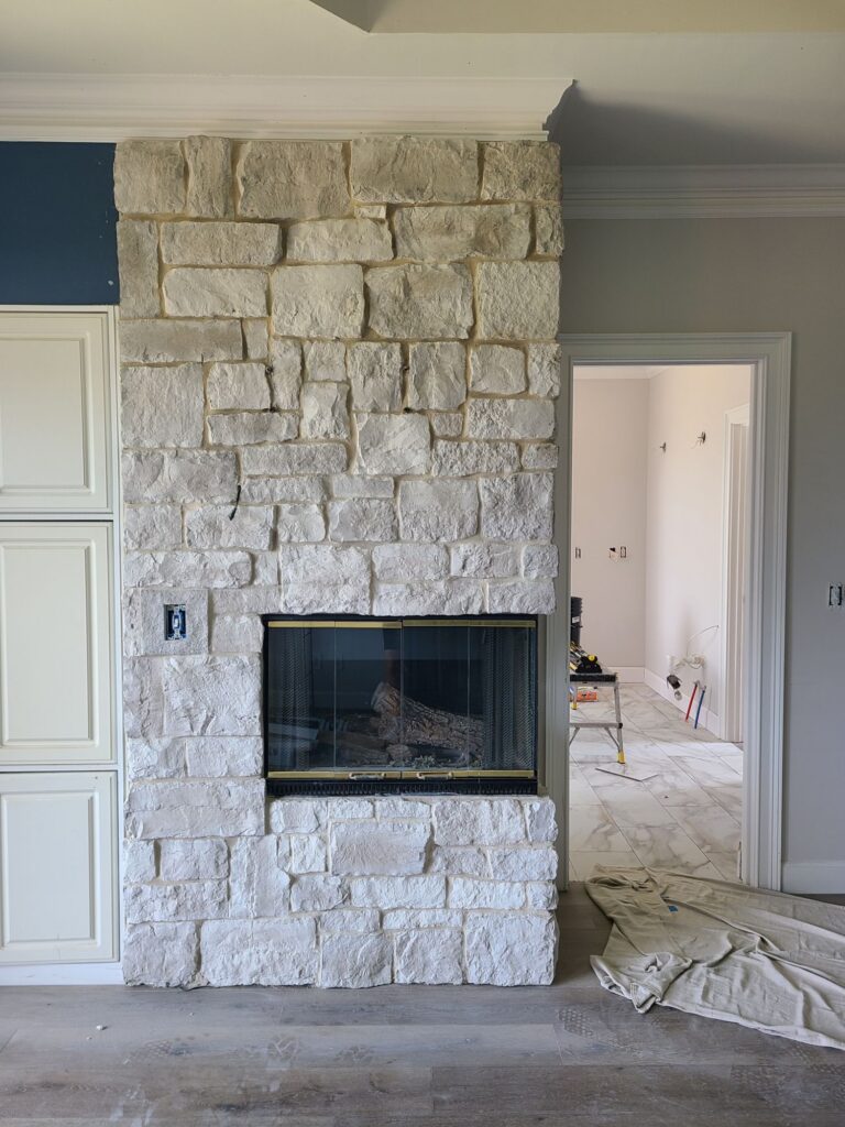 New stone fireplace with new flooring during the remodel