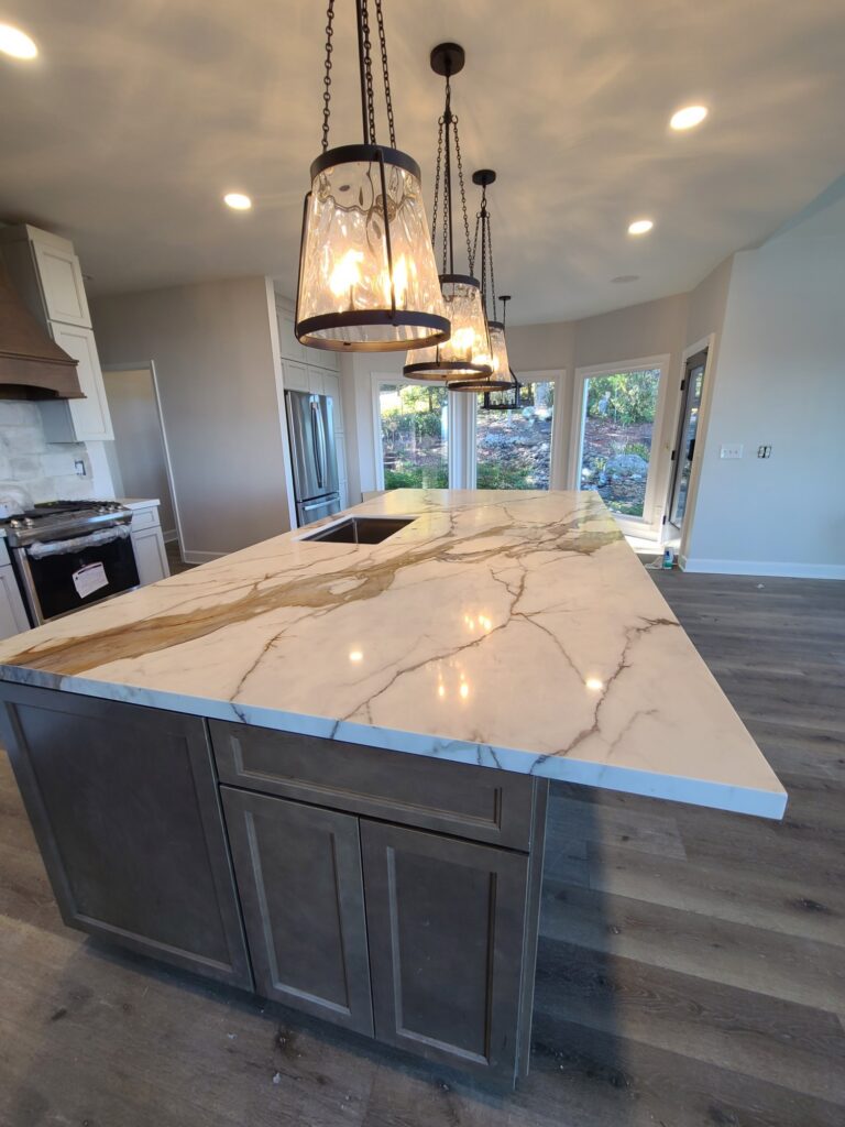Marble-look island under glass pendant lights