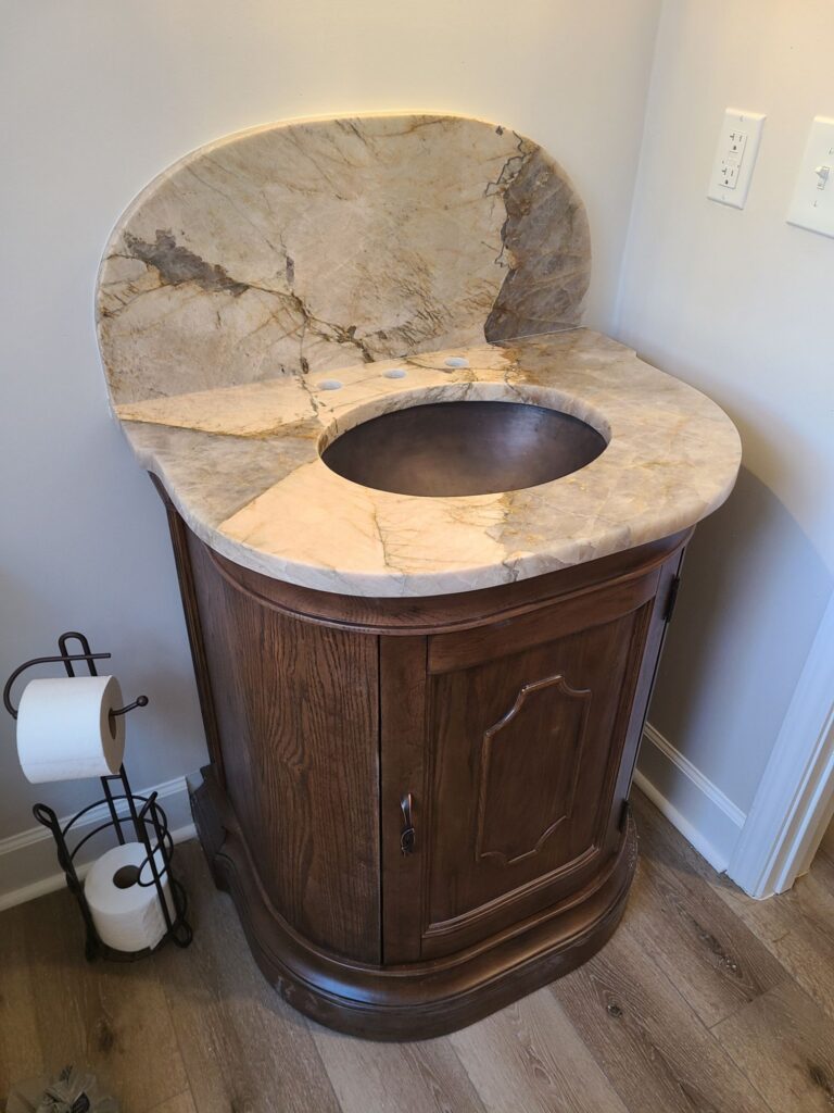 Powder room vanity with stone top and copper sink